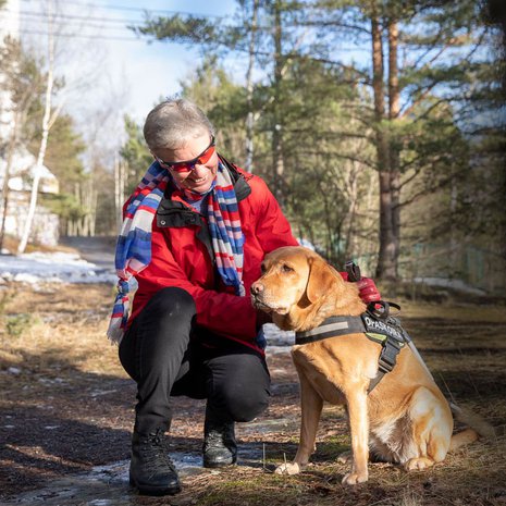Outi Lehtinen kulkee suojalasit päässä satoi tai paistoi. Lisäturvaa tuo valkoinen keppi ja opaskoira Ciru.